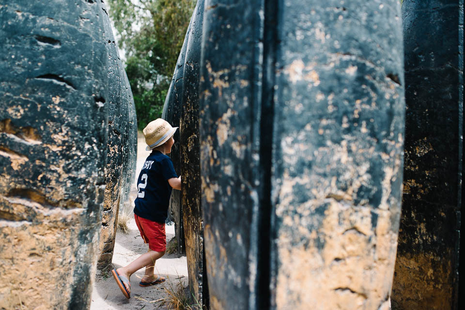 boy running through boulders - Documentary Family Photography