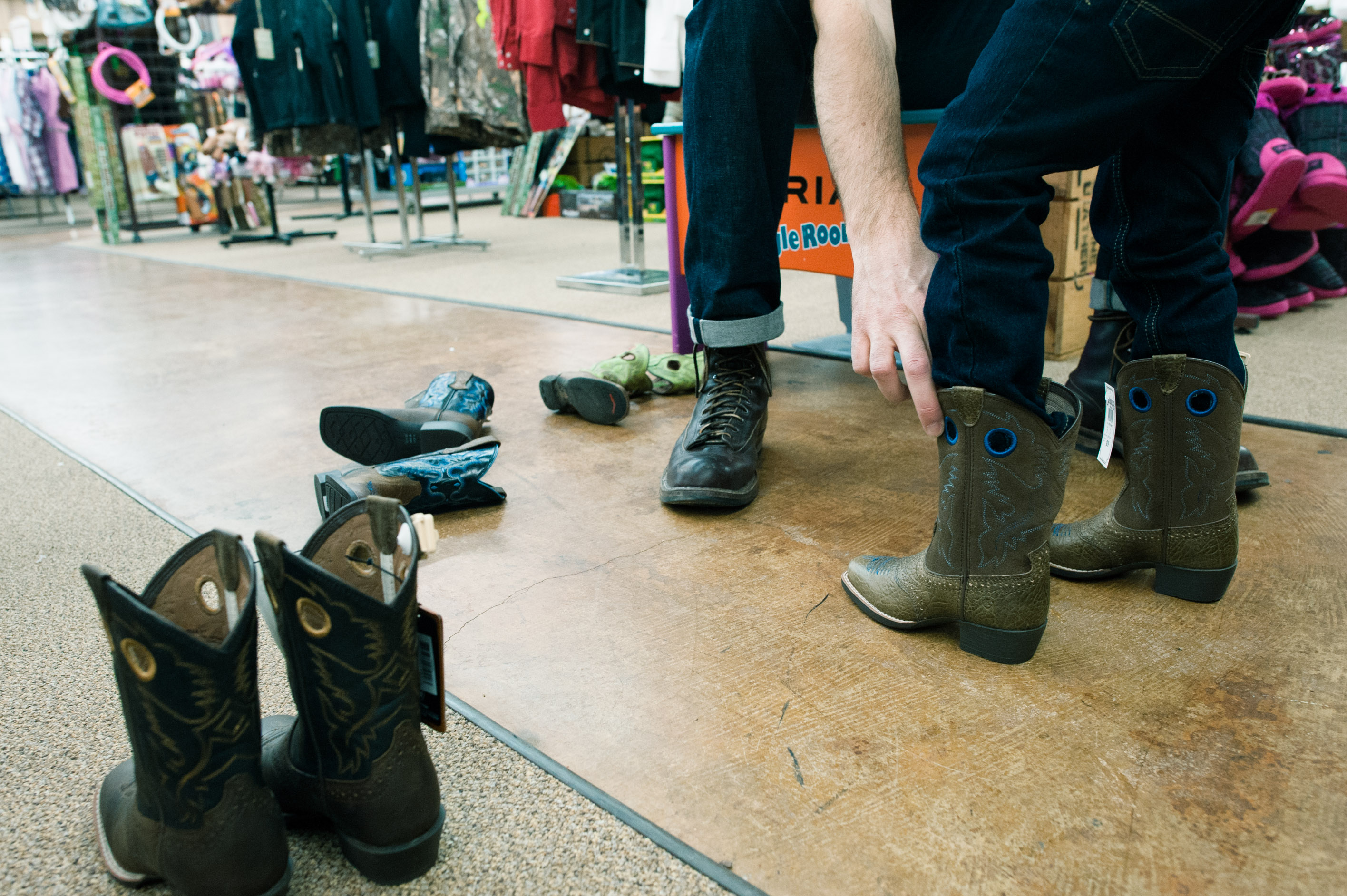 trying on cowboy boots - Documentary Family Photography