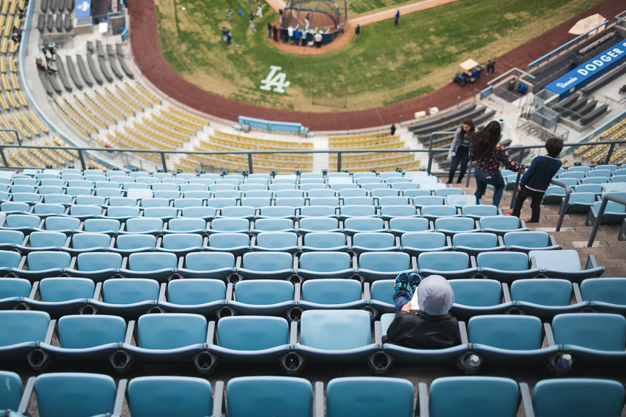 kid sitting alone in stadium seat - Documentary Family Photography