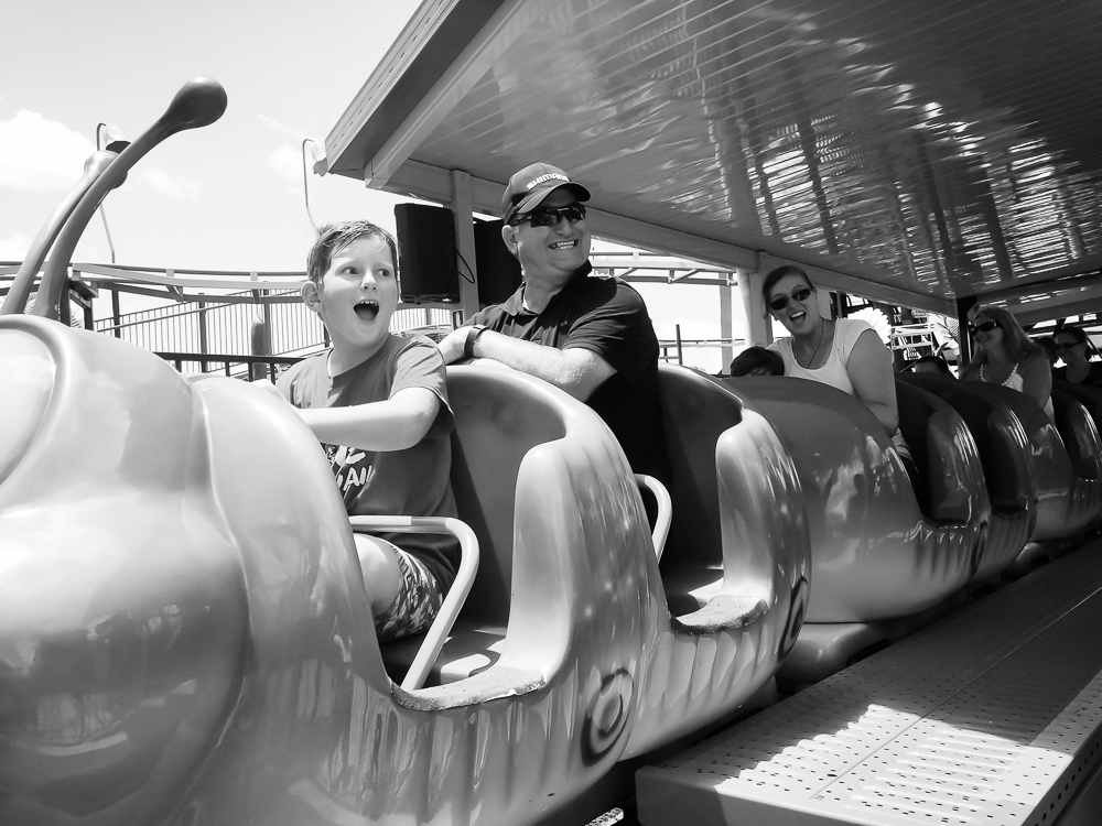 Family in roller coaster cars - Documentary Family Photography