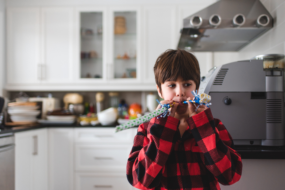 boy with party noisemakers - Documentary Family Photography