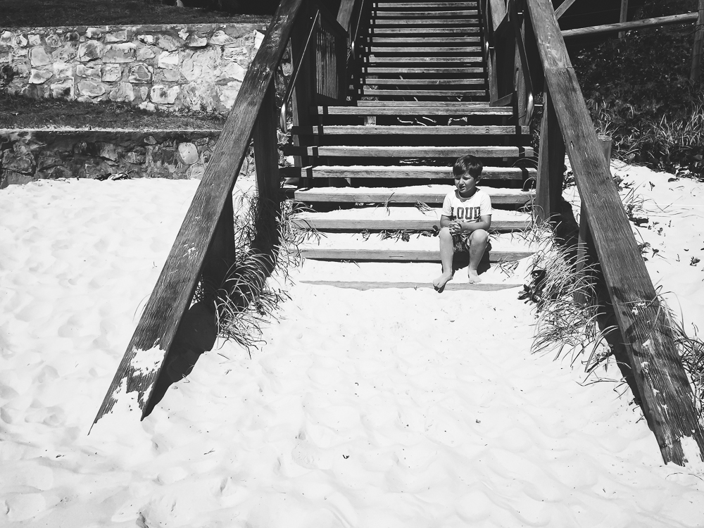 Boy sitting on beach stairs - Documentary Family Photography