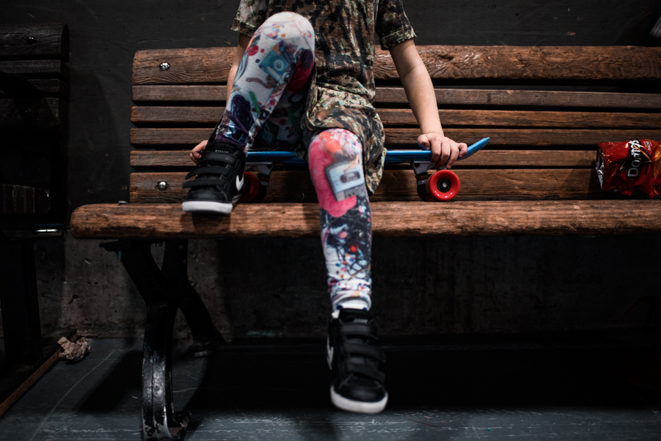 child sitting on skateboard - Documentary Family Photography