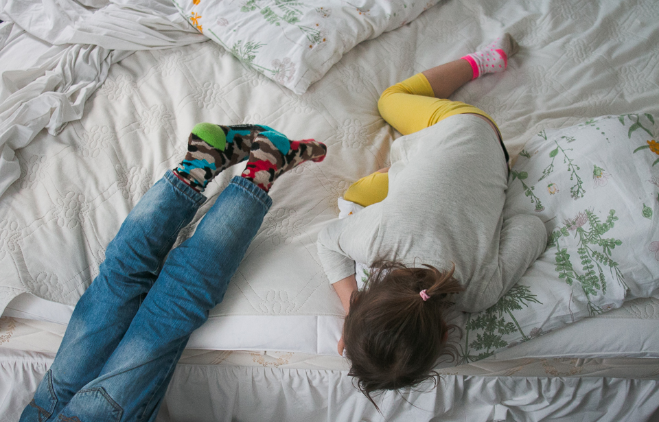 kids sprawled on bed - Documentary Family Photography