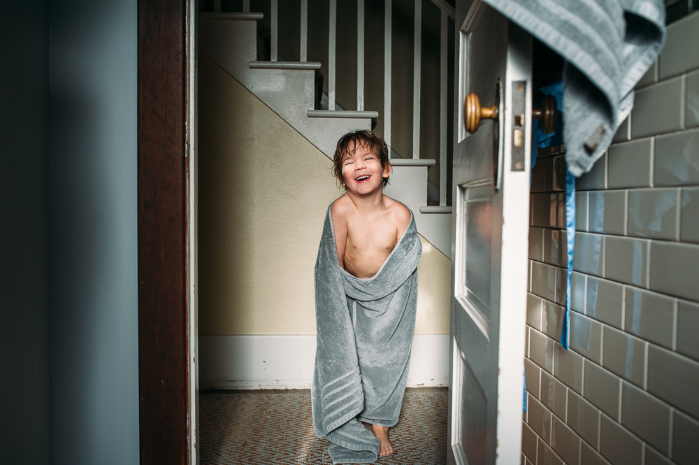 Boy laughs in towel - Family Documentary Photography