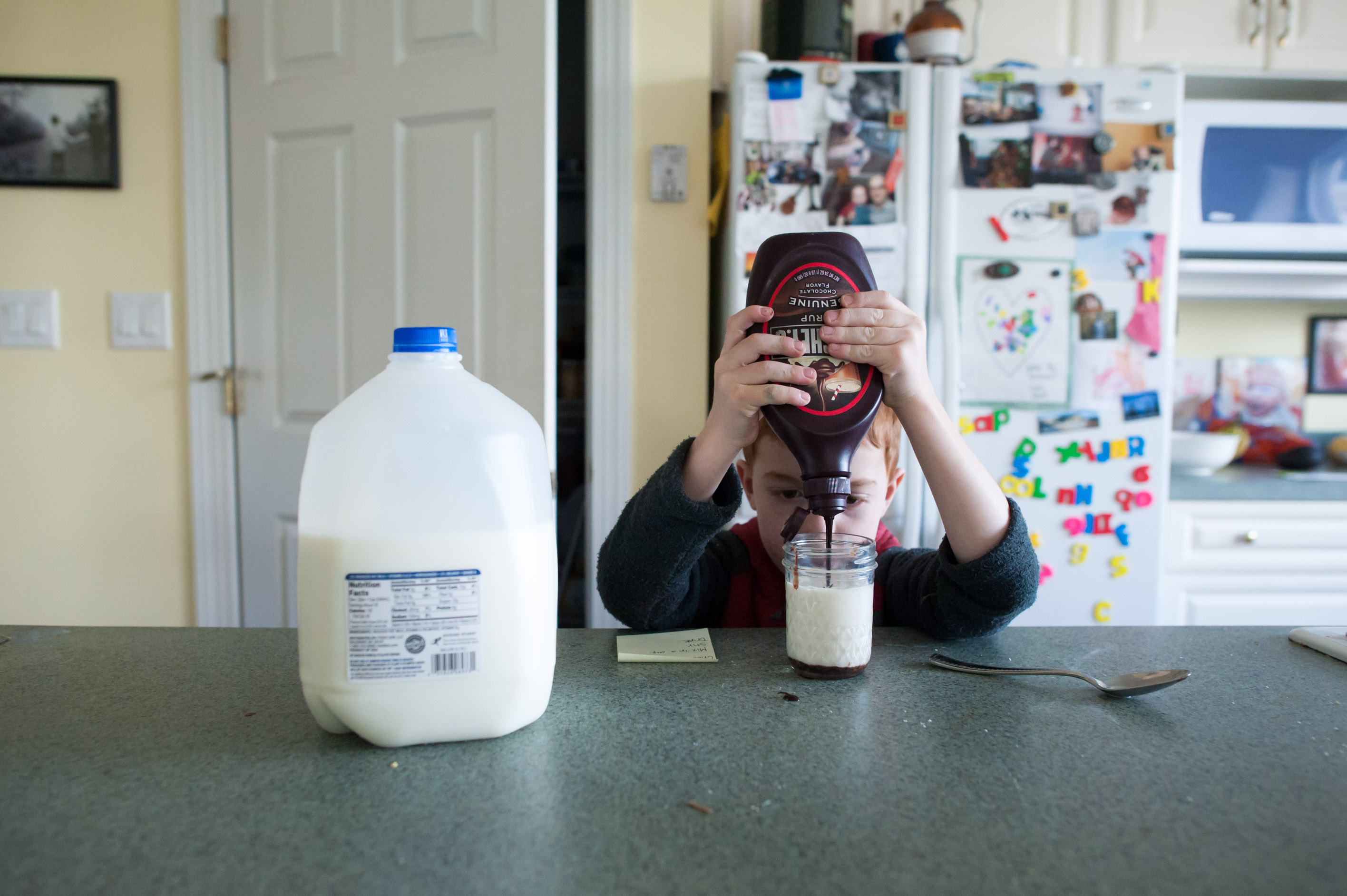 boy making chocolate milk - Documentary Family Photography