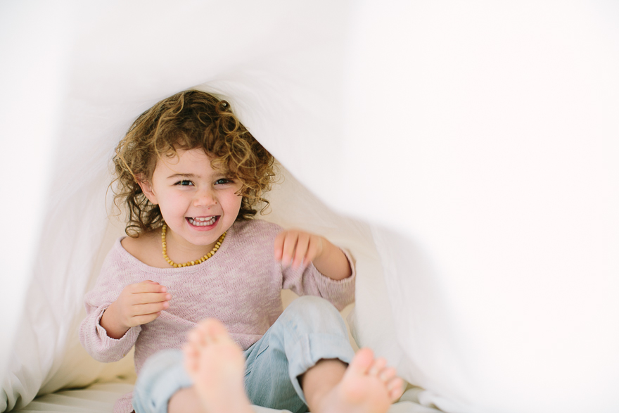 girl playing under blanket - Documentary Family Photography