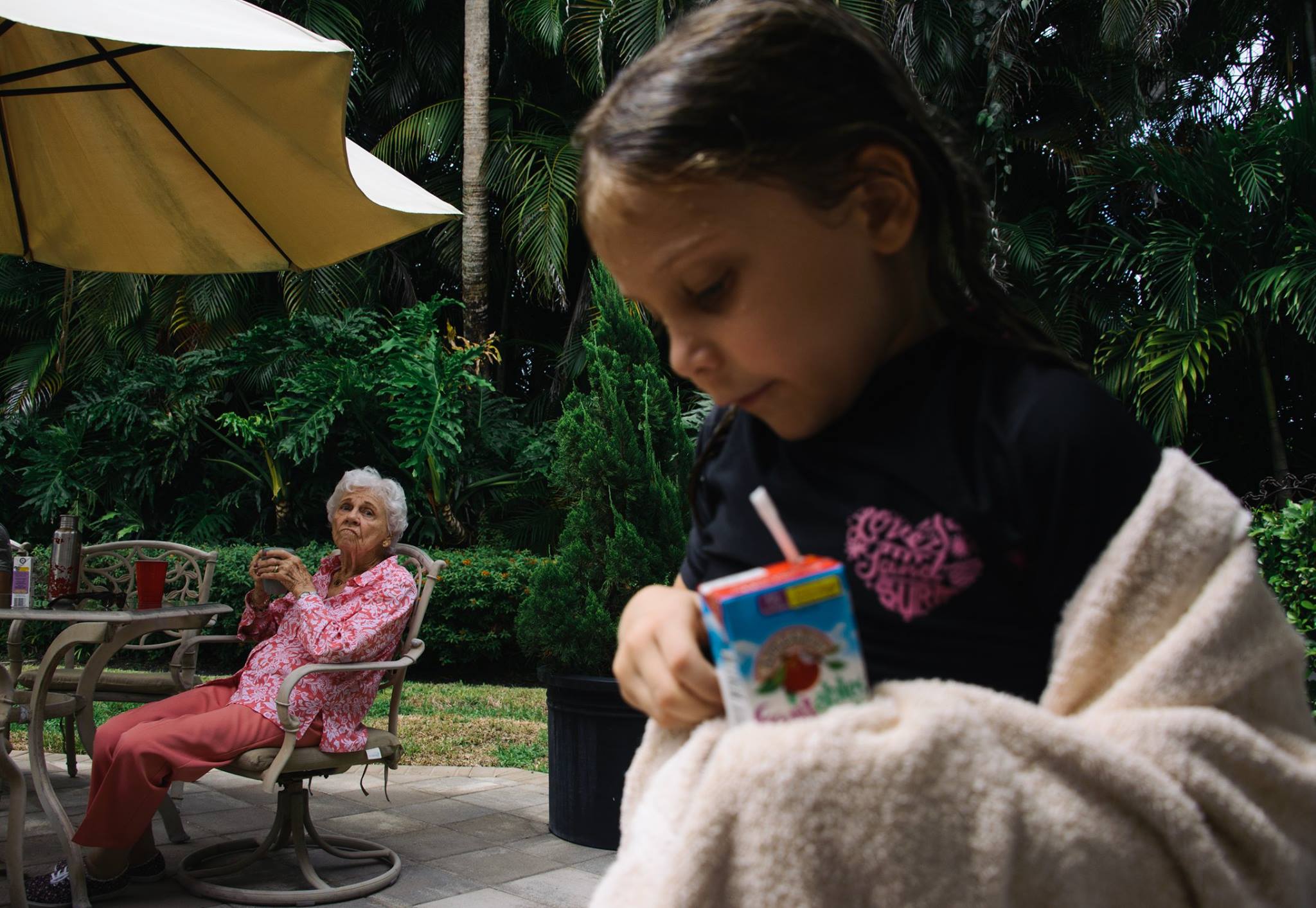 grandmother watches girl walk by at pool - Documentary Family Photography