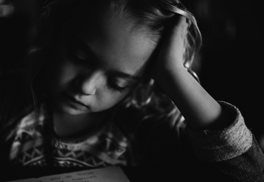 child concentrating on desk work - Studio Bloom - Documentary Family Photography