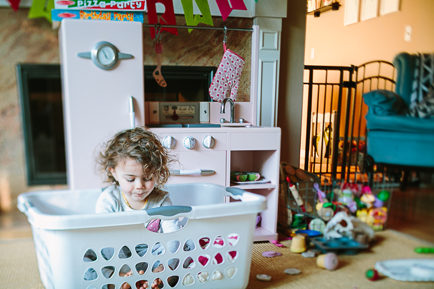 girl in laundry basket - Documentary Family Photography