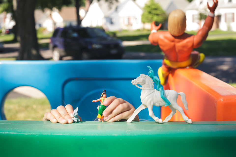 kids hands over top play house playing with toys