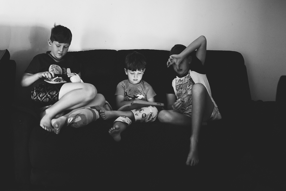 kids with electronics on couch - Documentary Family Photography