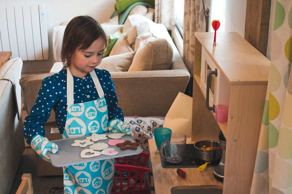 girl makes cookies at pretend kitchen - Documentary Family Photography