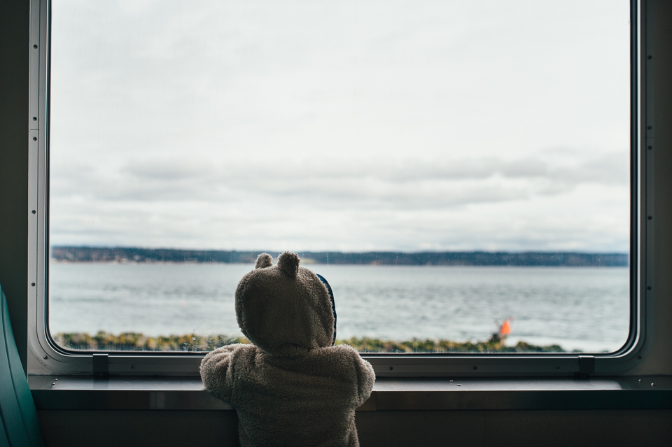 boy looking out ferry window - Documentary Family Photography