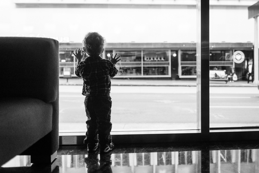 boy waiting at large window - Documentary Family Photography