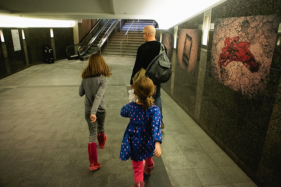 girls following father through train station - Documentary Family Photography