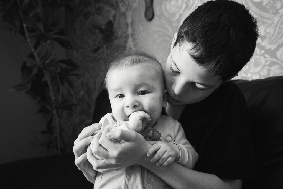 boy holding baby - Documentary Family Photography