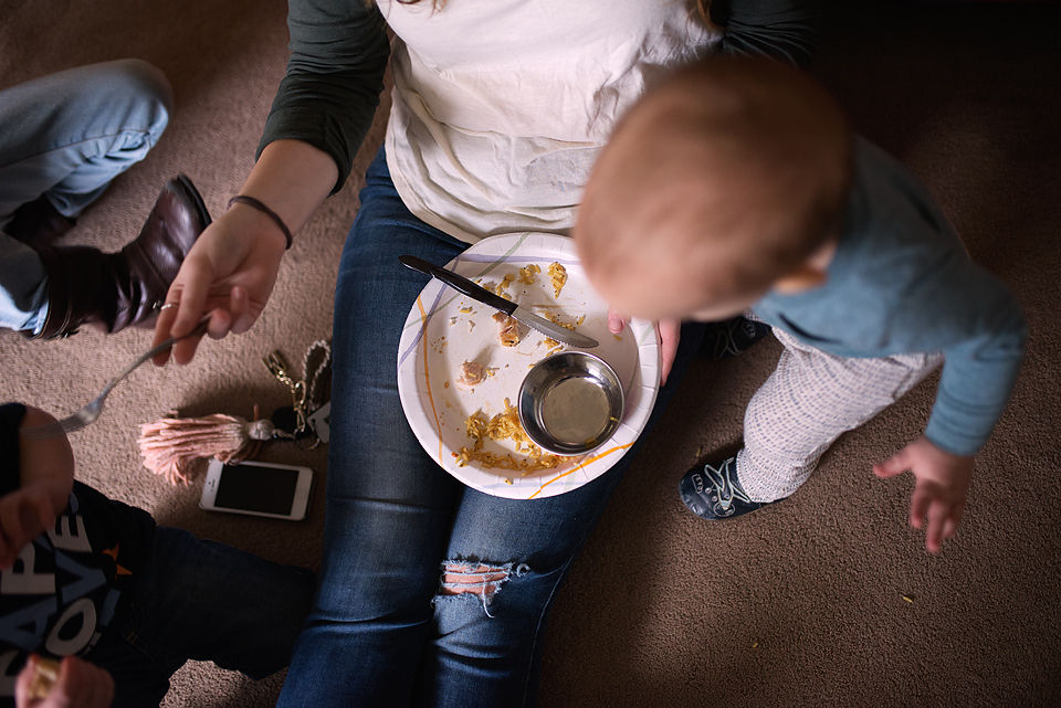 baby looks at empty plate -Documentary Family Photography