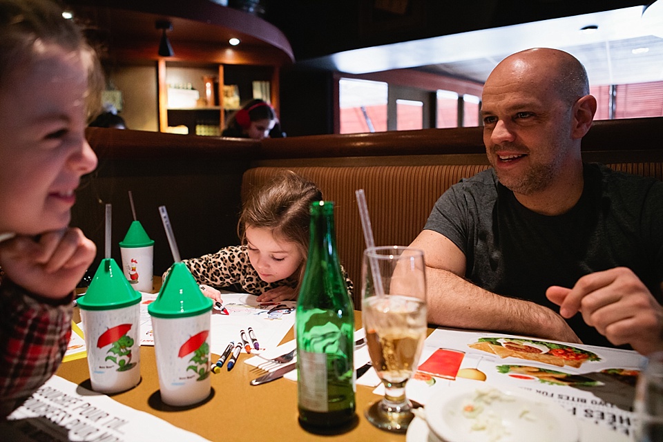 family at dinner in restaurant - Documentary Family Photography