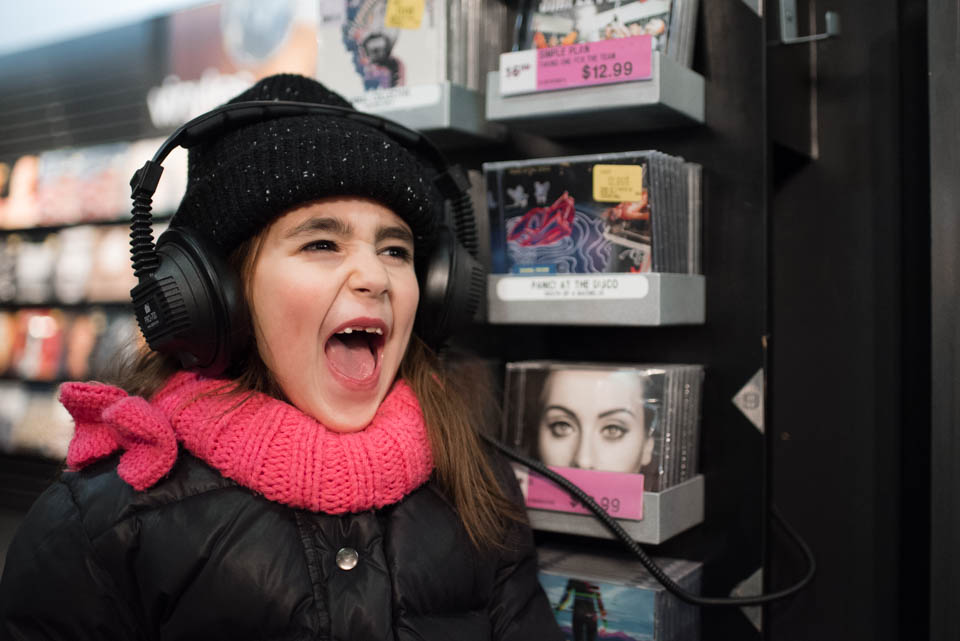 Girl yells with headphones on - Documentary Family Photography