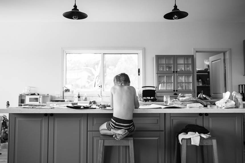 boy sitting at counter -Documentary Family Photography