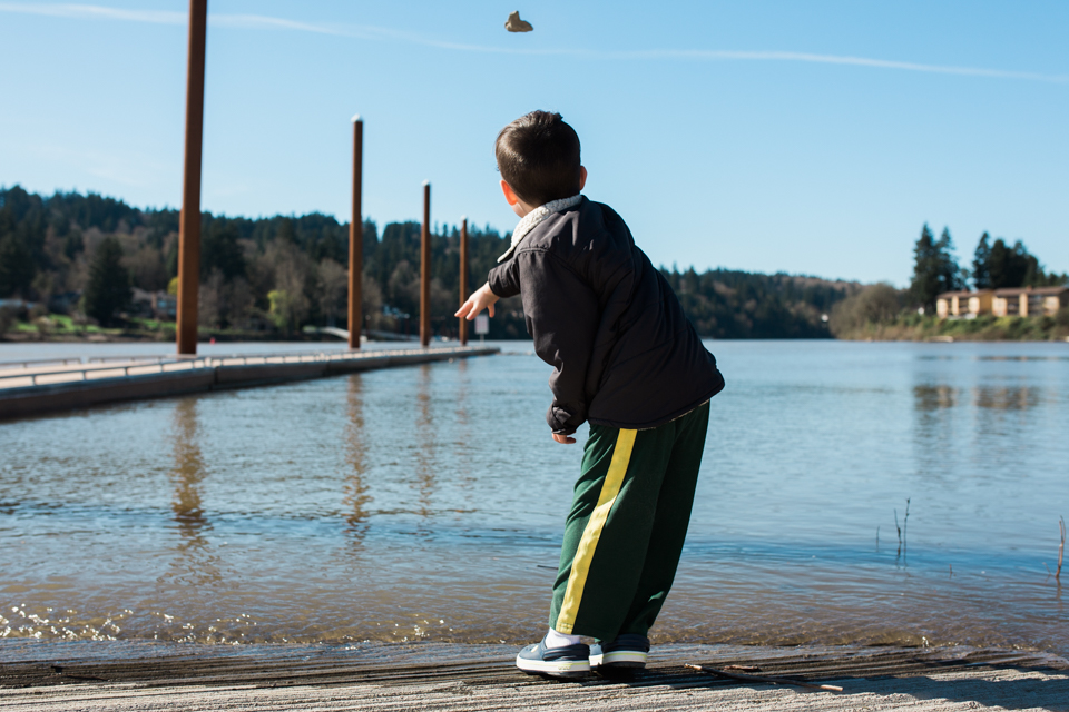 boy throw rock into lake - Documentary Family Photograpy