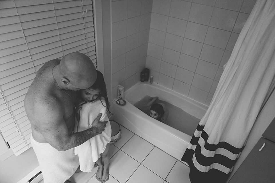 father helps daughter out of bath - Documentary Family Photograpy