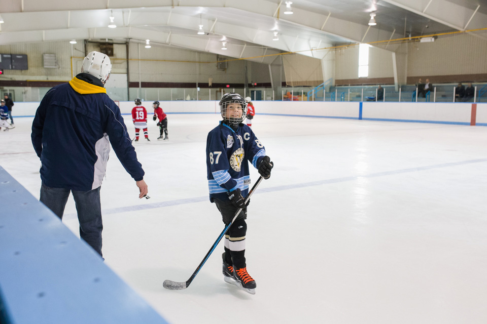 boy playing hockey - Documentary Family Photograpy