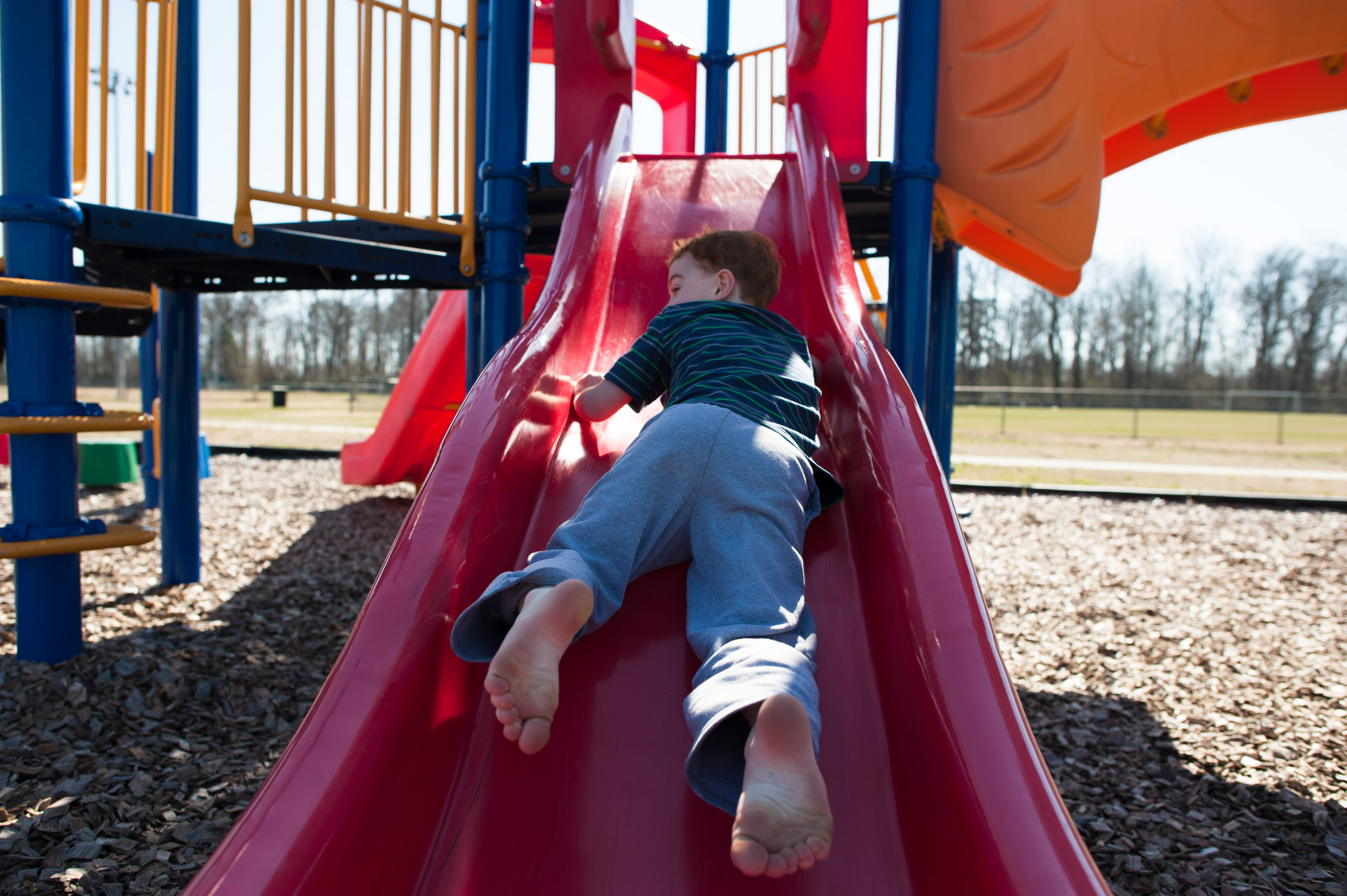 boy going down slide - Documentary Family Photograpy