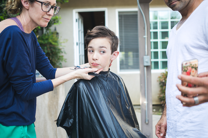 boy getting haircut outside - Documentary Family Photograpy