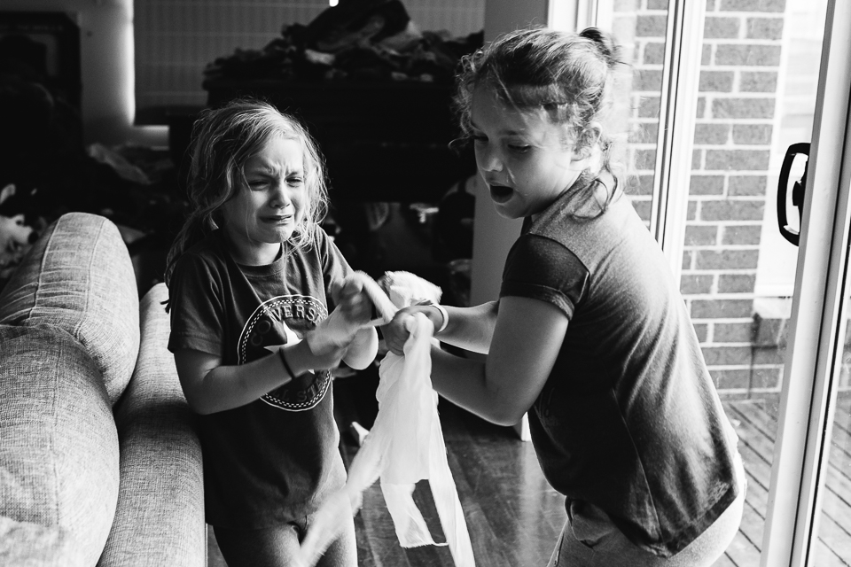 siblings fighting over toy - Documentary Family Photography