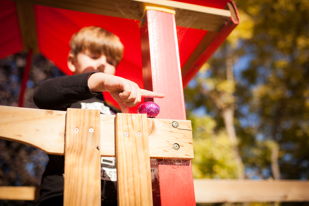 Boy with ball on play structure - Documentary Family Photography