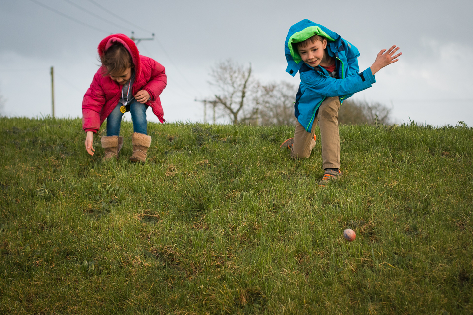 children rolling balls downhill - Documentary Family Photography