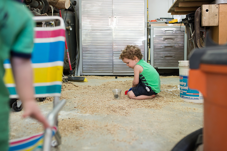 boy with cup and sawdust - documentary family photography