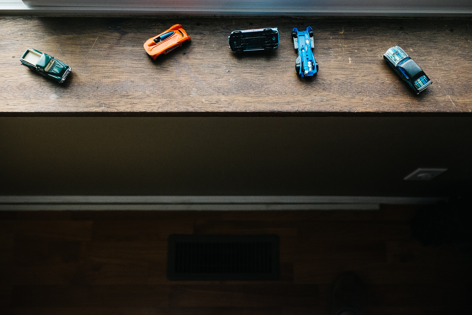 toy cars on windowsill - documentary family photography