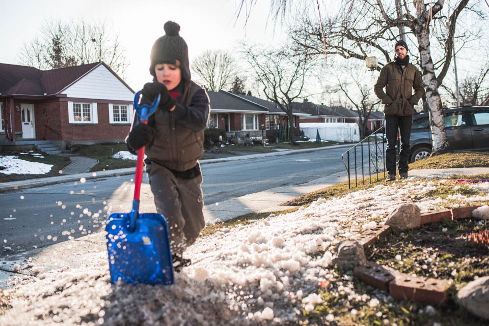 child shoveling snow - documentary family photography