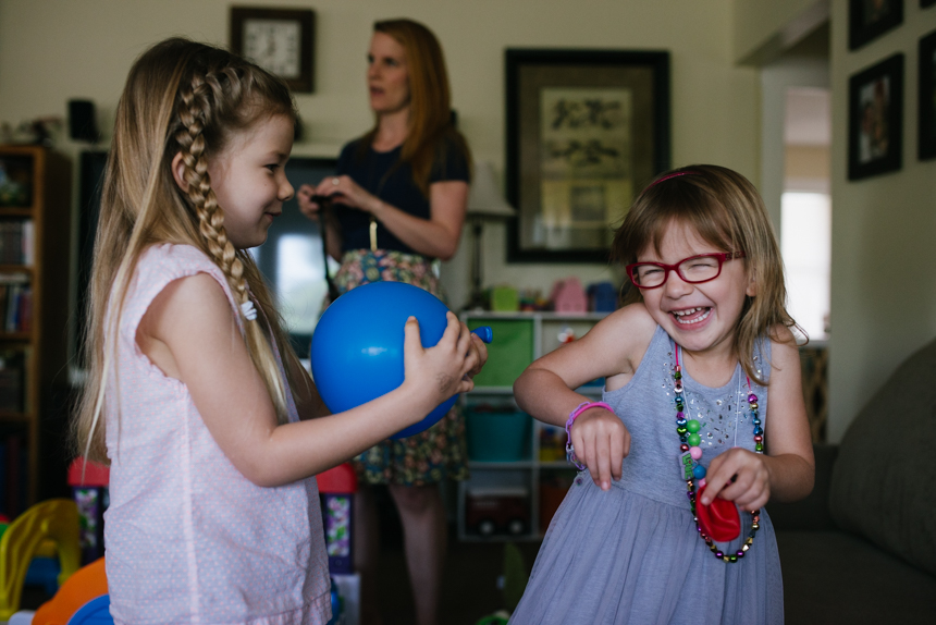 girls laughing at birthday party - documentary family photography