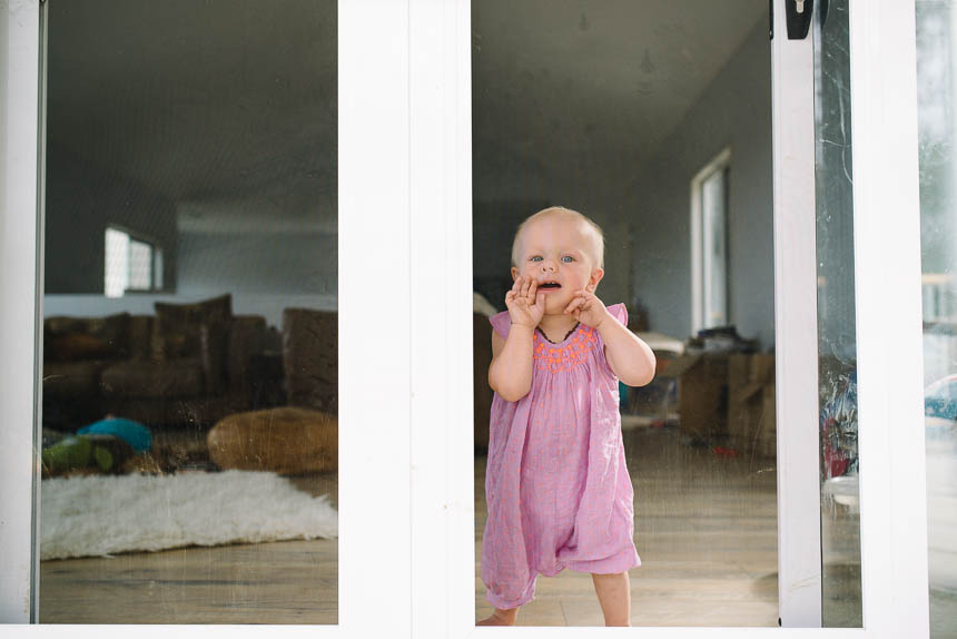 baby girl at window - documentary family photography