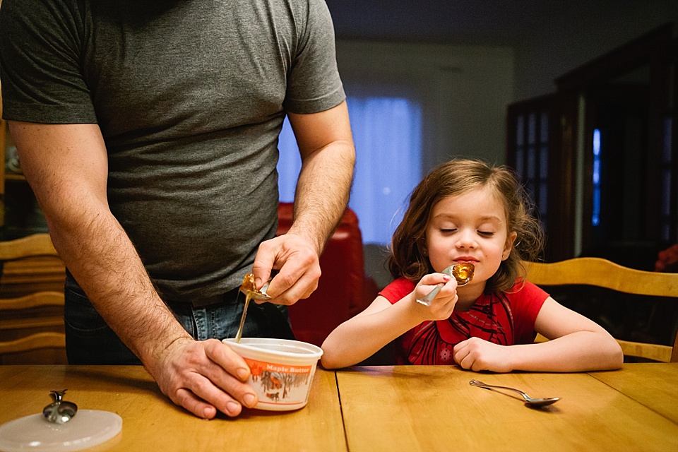 girl shares snack with father - Documentary Family Photography