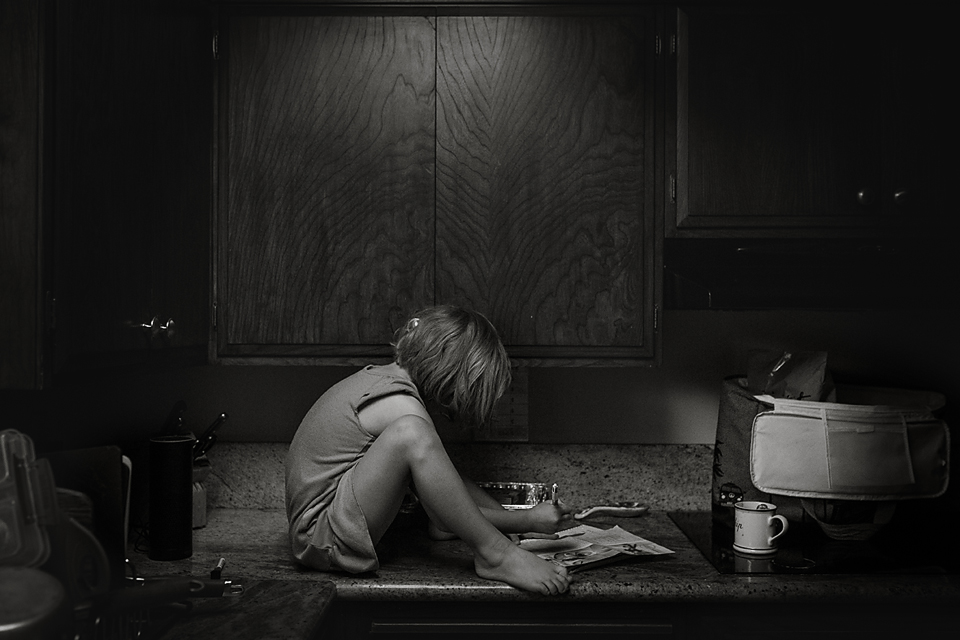 girl does homework on counter - Documentary Family Photography