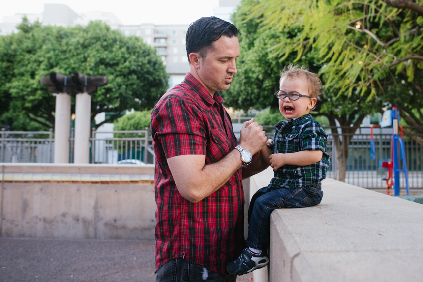 father comforts distraught boy - Documentary Family Photography