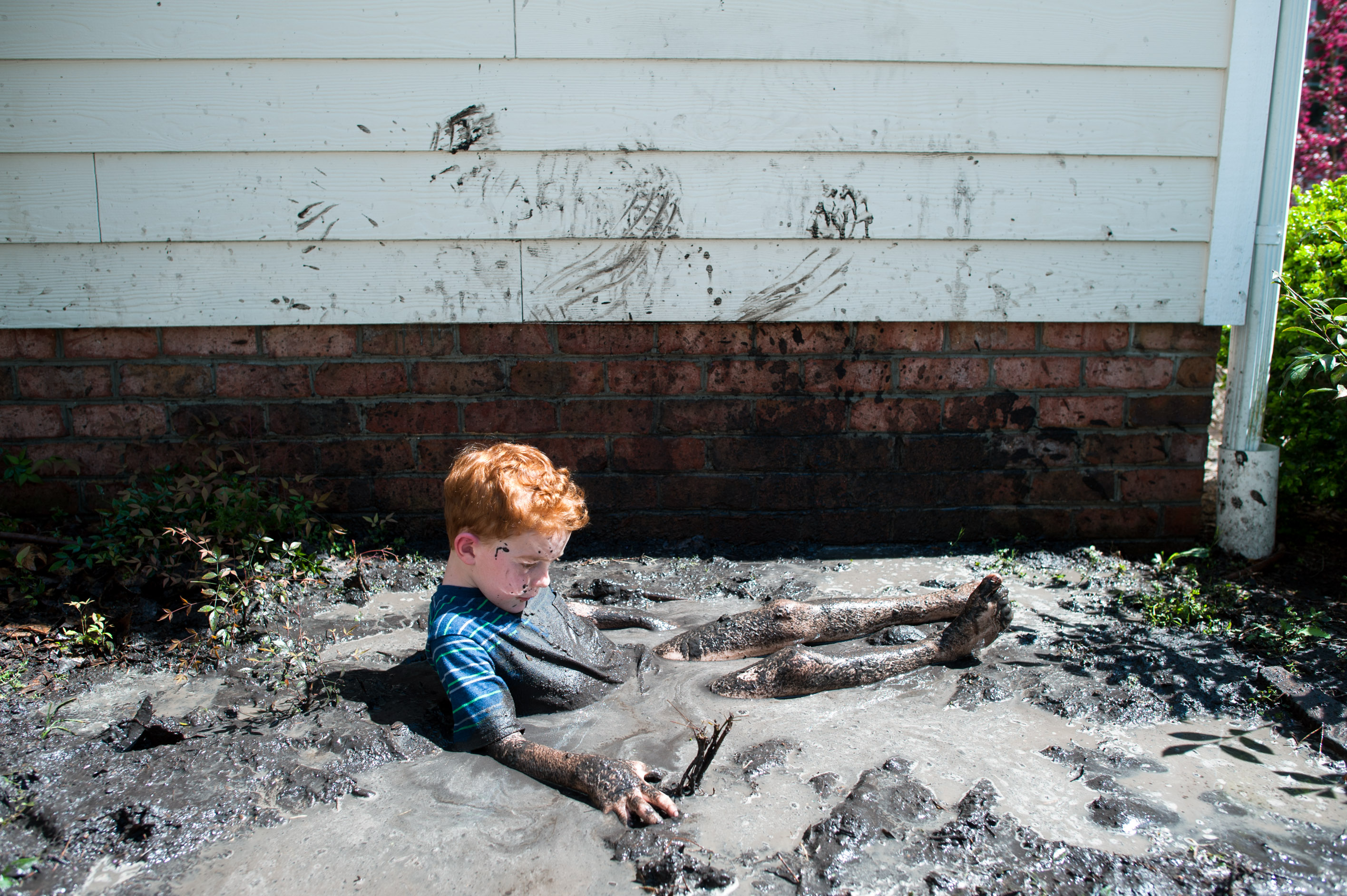 boy falls in mud puddle - Documentary Family Photography