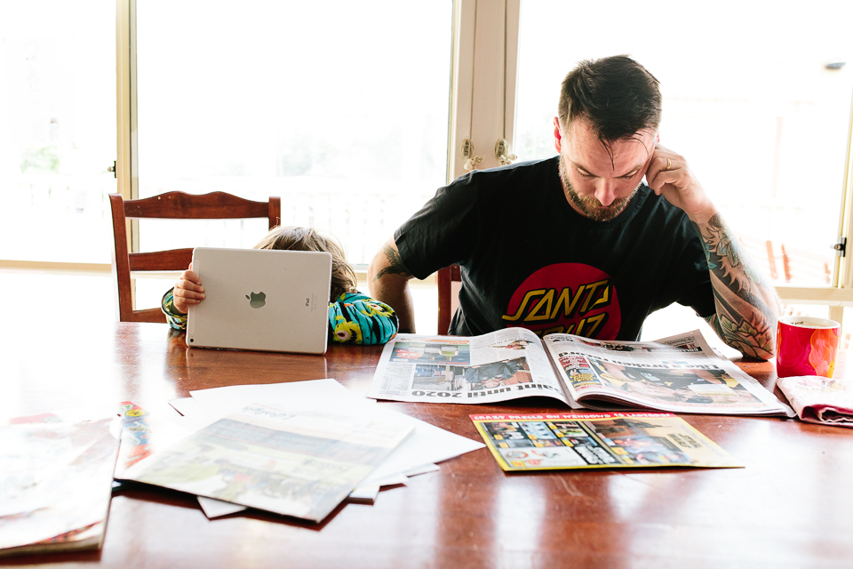Father and son reading at kitchen table - Documentary Family Photography