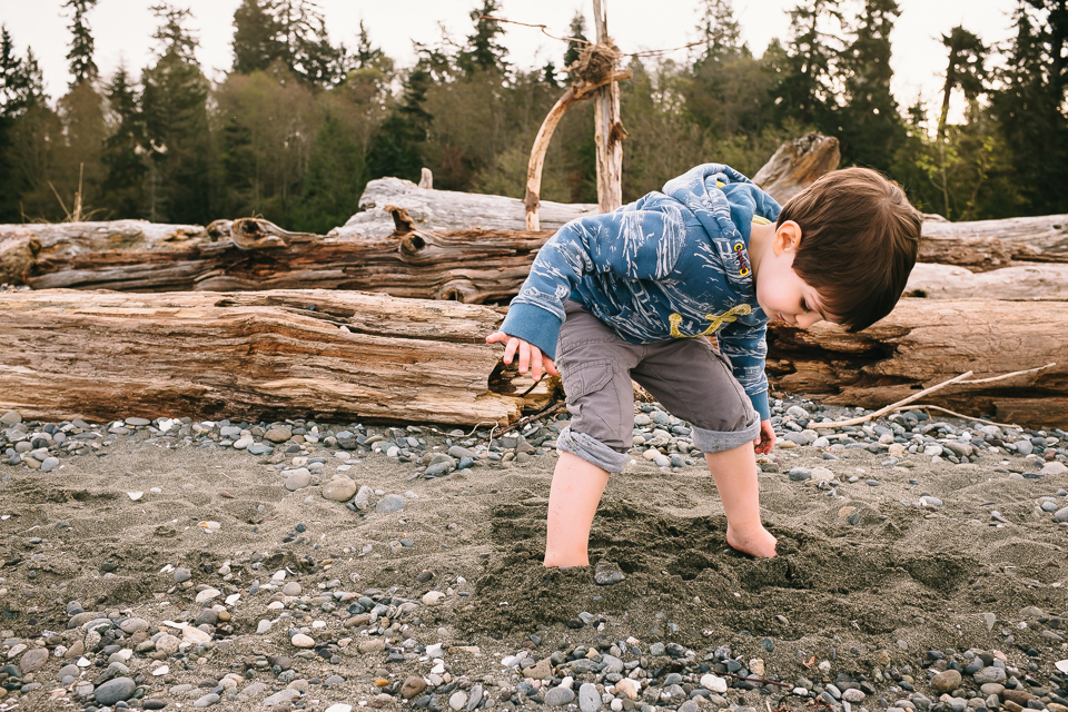 boy digging feet in sand - Documentary Family Photography