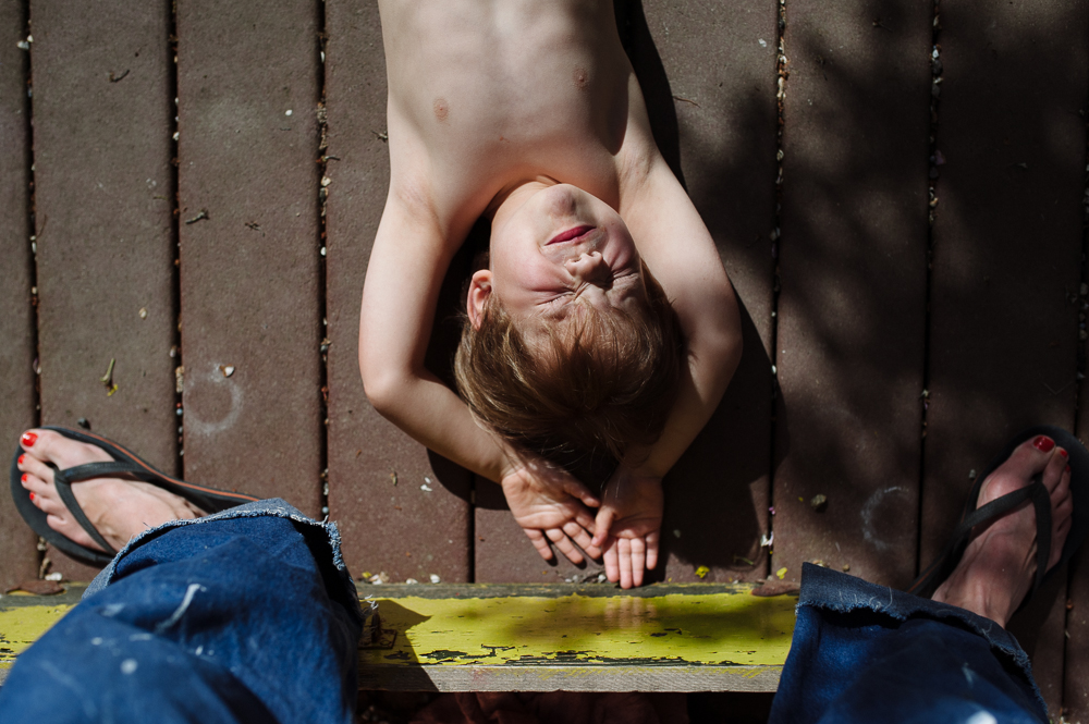 boy rests in sunlight on the porch - Documentary Family Photography