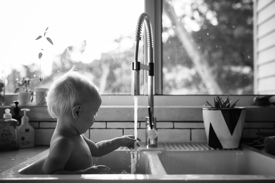baby having bath in sink - Documentary Family Photography