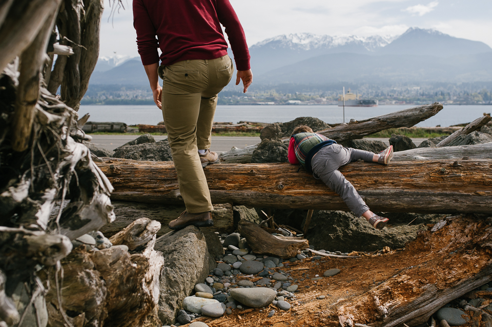 boy climbs over log - Documentary Family Photography