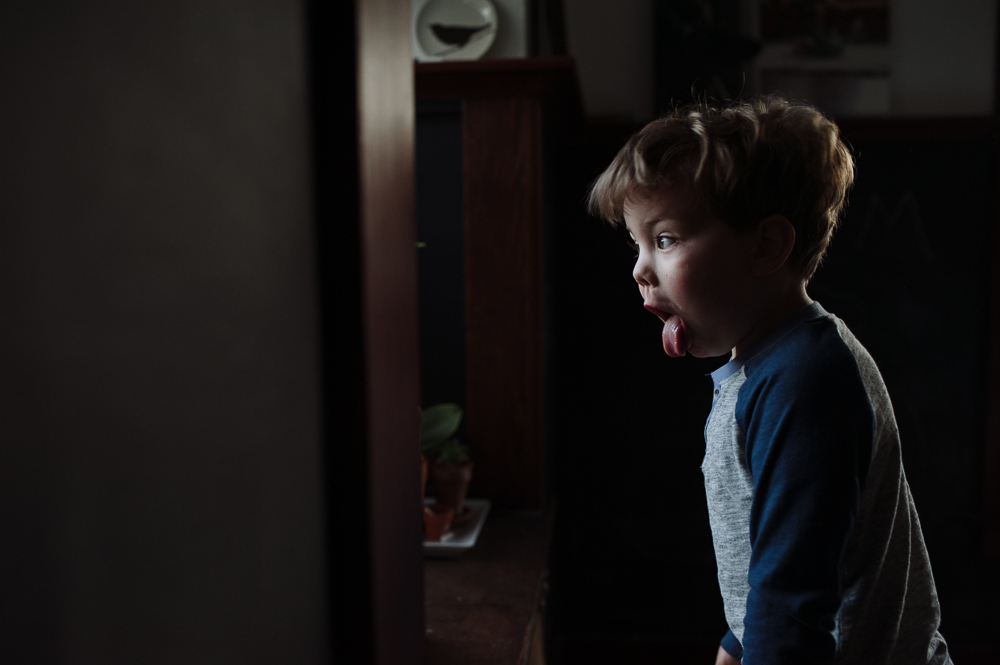 boy sticking out tongue - Documentary Family Photography