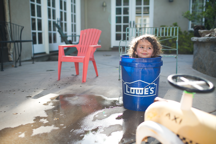girl playing in bucket - Documentary Family Photography
