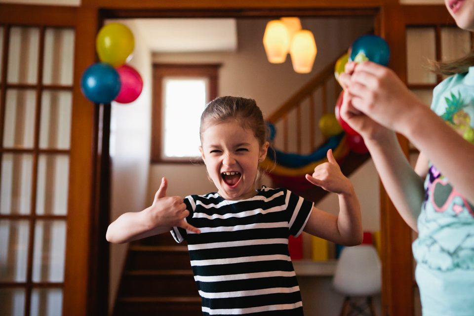 girl giving thumbs up on birthday - Documentary Family Photography